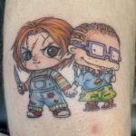 custom design Tattoo of Chucky Doll holding hands with Chuckie Finster from Rugrats. Done in the Lincoln City, Oregon area.